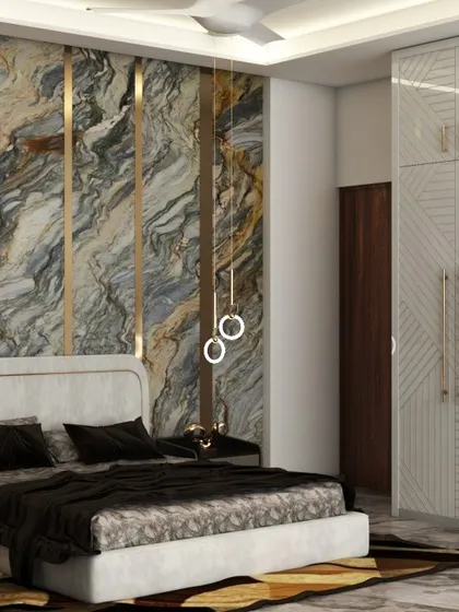 This master bedroom showcases our use of bold, luxurious materials. A floor-to-ceiling marble accent wall with integrated brass strips creates a dramatic backdrop for the custom upholstered bed, complemented by modern ring pendant lights.
