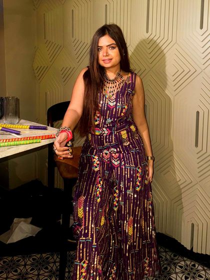 A sequined purple jumpsuit for a glamorous Navratri party look. This is a great alternative to traditional wear for a night of dancing.