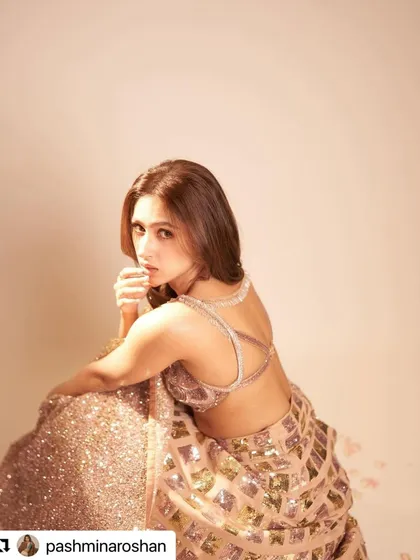 The soft curls and warm brown color create a romantic and elegant look for Pashmina Roshan.