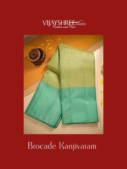 A brocade Kanjivaram in light green with a contrasting teal plain body, a unique and modern design.