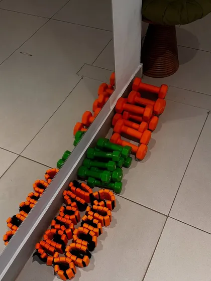 A colorful array of our yoga props, including ankle weights and dumbbells, ready for a yoga with weights class.