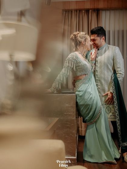 An intimate and artistic portrait of the couple. The soft focus and warm lighting create a dreamy, romantic atmosphere for their cocktail night.