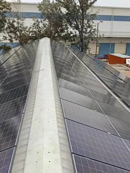 A close-up of the rooftop panel installation at the Bangalore hotel. The sleek, angular design is tailored to the building's structure, maximizing energy generation without compromising aesthetics.