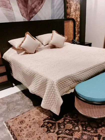 This design combines dark wood with natural cane for a sophisticated, contemporary look. The set includes a bed with a cane headboard and matching three-drawer nightstands.