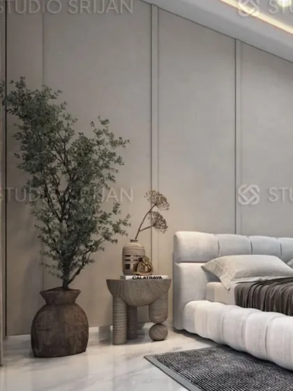 A bedroom in Mansarovar Garden with a calm, minimalist aesthetic, featuring a plush, low-profile bed and simple, clean-lined furniture.