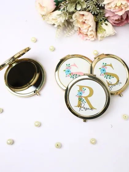 Our stylish and handy personalized pocket mirrors. These feature a floral design with a custom name and initial, making them a perfect small gift or bridesmaid favor.