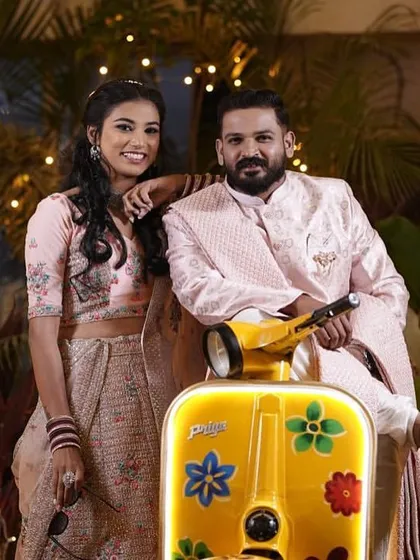 A fun and stylish shot of a couple posing with our iconic yellow scooter photo prop.