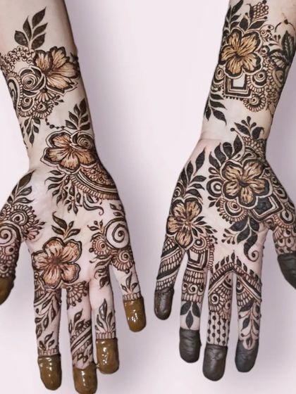 A beautiful floral party henna with hibiscus flowers, showcasing a mix of bold lines and delicate shading.