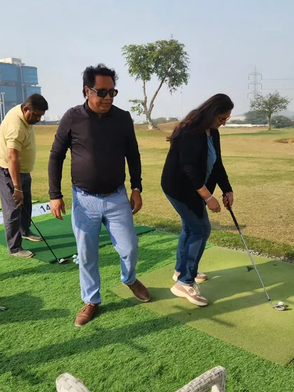 A group of friends trying out our putting green together. It's a great spot for some lighthearted competition and fun.