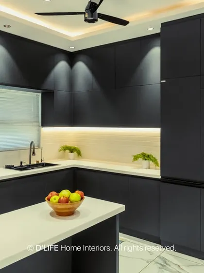 A bold, all-black modular kitchen that makes a powerful statement. Handleless cabinets and integrated appliances create a seamless, ultra-modern look, enhanced by strategic lighting.
