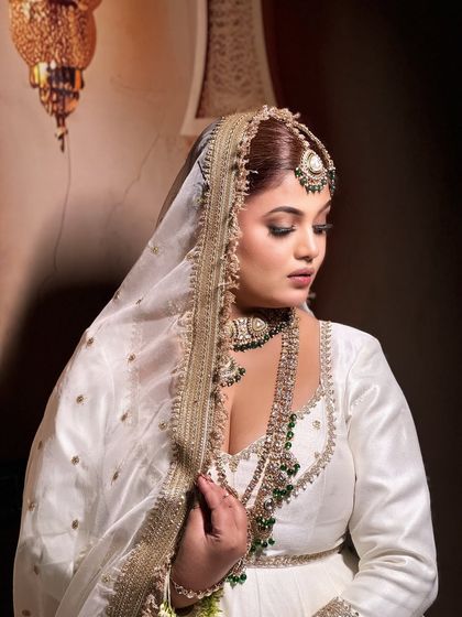 The side profile, showcasing the traditional 'passa' jewellery and the soft contouring of the face.