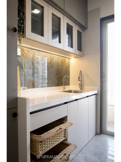 A detail of the kitchen counter at KVK Camellia, showing the fluted glass cabinet doors and the beautiful stone backsplash. We use high-quality materials to elevate the look and feel of our kitchens.