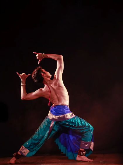 A powerful pose conveying strength and divinity, often used to depict gods or heroes. The angularity and energy are characteristic of the Kuchipudi style.