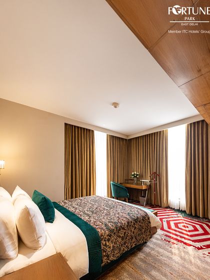 The geometric patterns of the rug complement the clean lines of the furniture in this room. Every element is chosen to create a visually pleasing and comfortable environment.