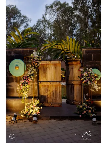 An entrance should be the first chapter of your event's story. I designed this modern broken arch with cascading florals and warm uplighting to create a dramatic and elegant welcome for a sangeet night.