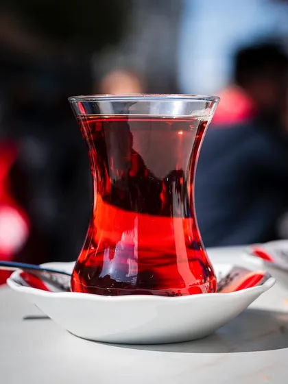 Another take on Turkish tea, this time with a blurred background that gives a sense of a bustling cafe while keeping the tea as the sharp, central focus.