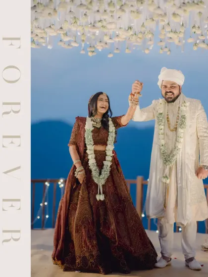 A moment of pure happiness after the ceremony. The bride raises her hand in celebration, her joyful expression perfectly capturing the emotion of becoming "forever."