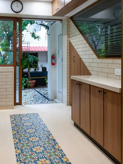 The patterned floor tiles in this kitchen act as a runner, leading from the outdoor patio into the heart of the home. It’s a small detail that makes a big impact, connecting the different zones of the house.