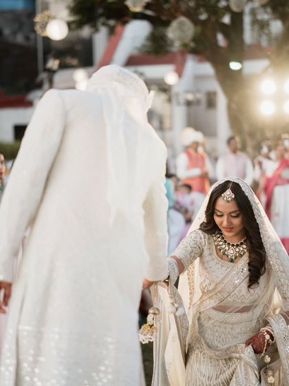 The groom leads his bride during their beautiful outdoor wedding ceremony in the Mahabaleshwar valley.