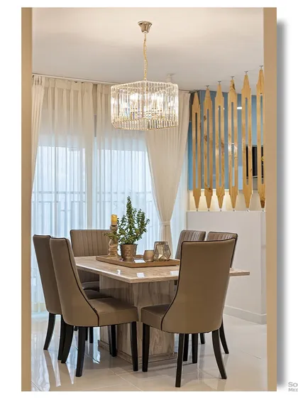 A glimpse into an elegant dining area, framed by a doorway. The crystal chandelier and marble-topped table create a sense of luxury, while the wooden screen adds a touch of modern design.