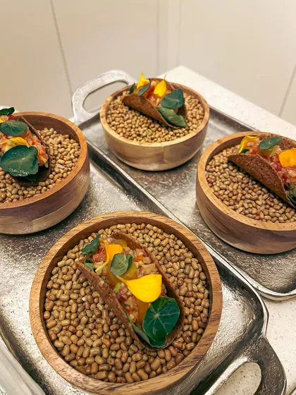 Canapé-sized mushroom tacos, filled with fermented garlic aioli, green papaya som tam, and a truffle egg yolk gel.