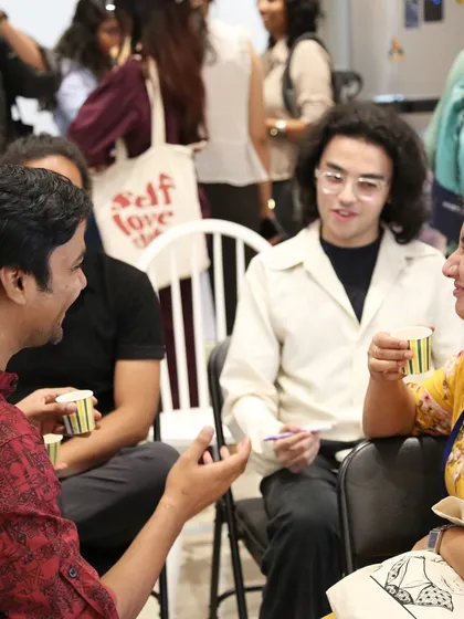 Attendees networking over chai at our event for young poets.
