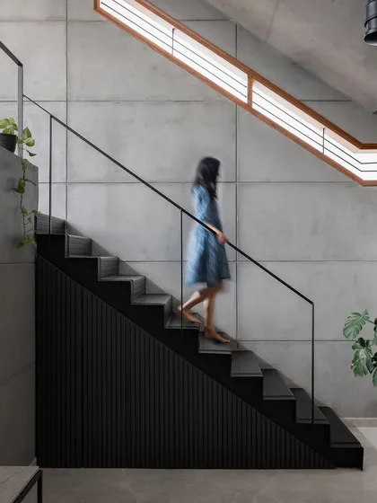 We love letting honest materials tell the story. This folded checkered plate staircase at our 'Triode' project creates a strong industrial statement against the raw exposed concrete walls, showing how functional elements can become sculptural highlights.