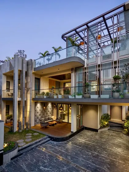 I believe landscaping should complement the architecture. For this modern villa in Faridabad, I used a mix of potted plants on multiple balcony levels and a curated ground-floor garden to soften the building's strong lines and integrate it with its natural surroundings.