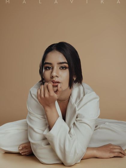 A close-up from the editorial shoot, showing the clean, defined makeup that enhances the model's features.