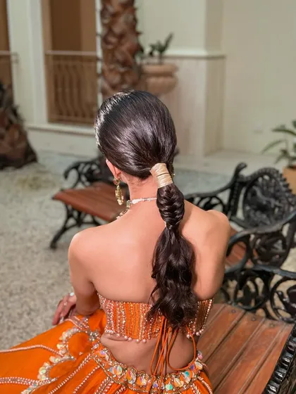 A detailed shot of the sleek, modern ponytail. This hairstyle is chic and practical, keeping the hair off the face while still making a statement.
