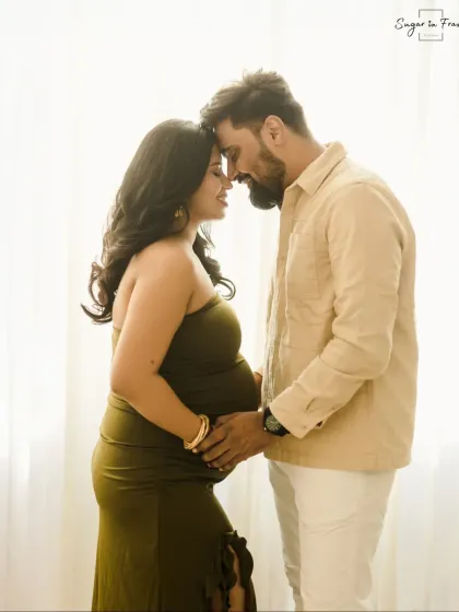 A beautifully backlit silhouette of an expecting couple, highlighting the baby bump. This artistic shot creates a feeling of intimacy and timeless love.