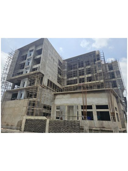 Another view of the Miner’s Training Academy during construction, with scaffolding covering the façade. This phase is critical for translating the architectural vision from drawings into a physical, three-dimensional reality.