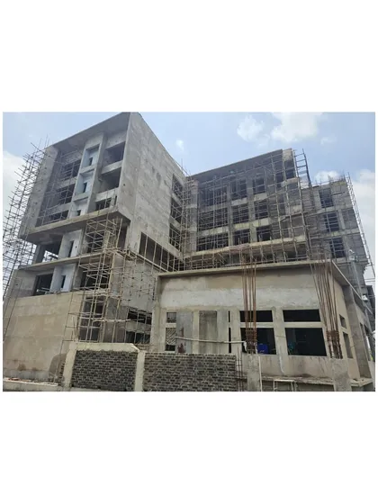 Another view of the Miner’s Training Academy during construction, with scaffolding covering the façade. This phase is critical for translating the architectural vision from drawings into a physical, three-dimensional reality.
