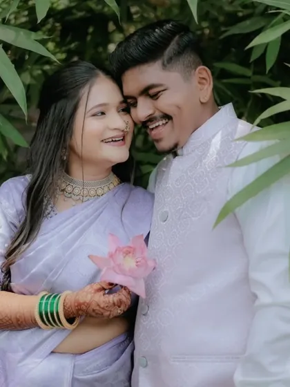 A happy couple during their engagement shoot. The bride's beautiful mehndi is a lovely part of their celebration, adding a touch of tradition and art.
