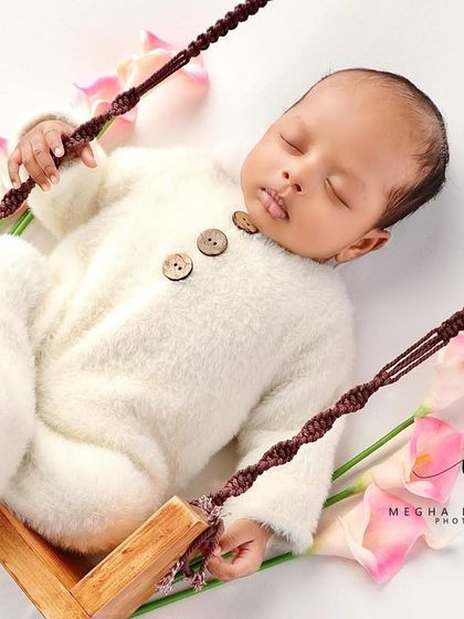 A wider view of the swing setup, adorned with pink flowers.