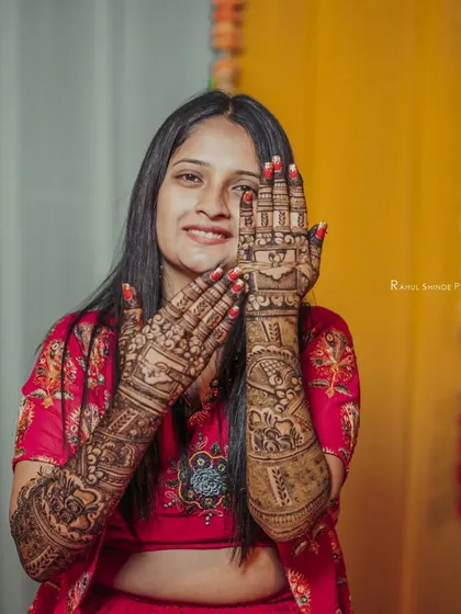 Another joyful shot of the bride with her full bridal mehndi. The design is filled with personal elements and traditional motifs.