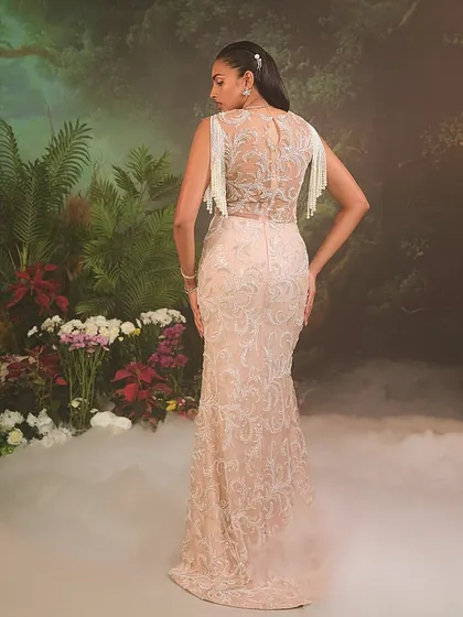 A view of the Nuray Gown's back, where the intricate embroidery continues across a sheer panel, offering a look that is as detailed from the back as it is from the front.