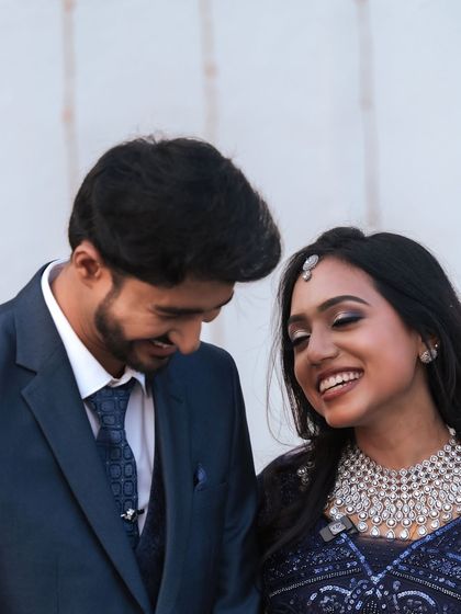 A close-up of the couple sharing a happy, intimate moment. Dr. Akshara's makeup looks flawless and enhances her joyful expression.