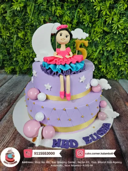 A beautiful two-tier doll cake in purple, celebrating a 5th birthday. The details on the doll's dress and the starry theme make it a magical choice.