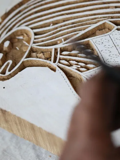This is the story of a Yawkyawk (young woman mermaid) design by artist Janet Marawarr. Her original lino tile is being carefully translated into a woodblock by our carvers, preserving the story for our collaborative textile collection.