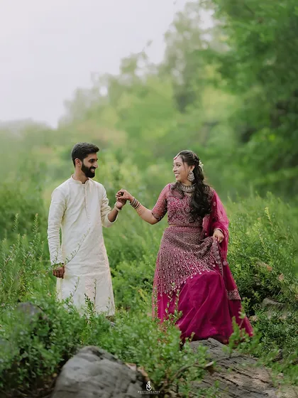 Walking hand-in-hand through the tall grass. The movement and their happy expressions make this a lively and romantic shot.