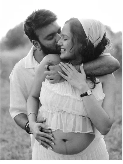 A tender kiss, a gentle embrace. This black and white close-up captures the pure affection and happiness between the expecting couple, making for a timeless and emotional maternity portrait.