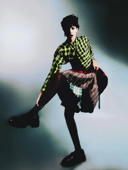 A dynamic, high-energy pose that captures the fun and freedom of personal expression. The motion blur adds to the spontaneous feel of the shot.