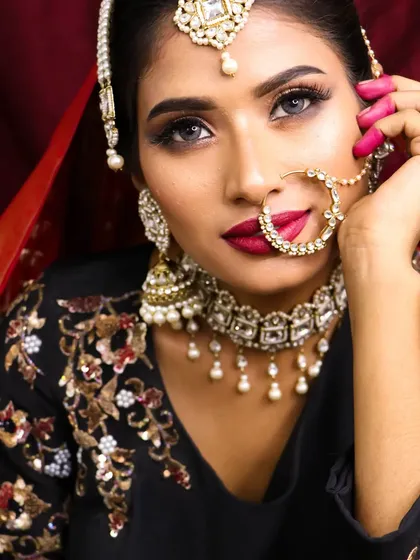 The right amount of makeup is a game-changer. This look features a bold smokey eye and a deep berry lip, perfect for a bride who wants a dramatic reception style.