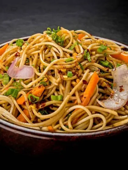 A glimpse of our popular Indo-Chinese menu. This is our signature Veg Hakka Noodles, stir-fried with crisp vegetables and our special sauce blend, perfect for wedding receptions and parties.