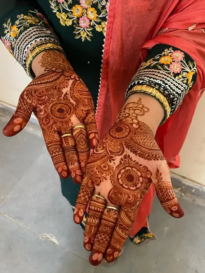 The final stain from a detailed bridal mehendi, showing both hands. The color is deep and even.