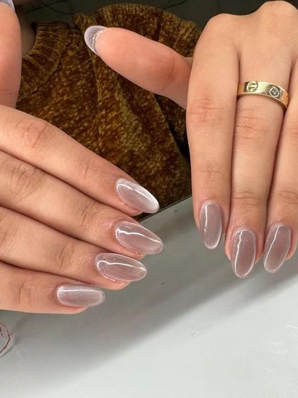 This is a sheer, pearlescent "jelly" manicure. The translucent, glossy finish gives the nails a healthy, glowing look that is both minimalist and chic.
