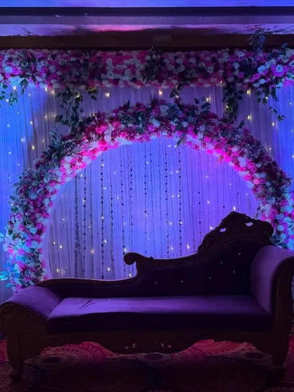 A moodier shot of the ring ceremony stage, where the deep blue and pink lighting creates a more intimate and romantic atmosphere.