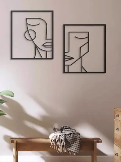 This set of two sleek iron wall art pieces features abstract line-art faces. The minimalist black design is modern and sophisticated, with size customization available to perfectly suit your space.