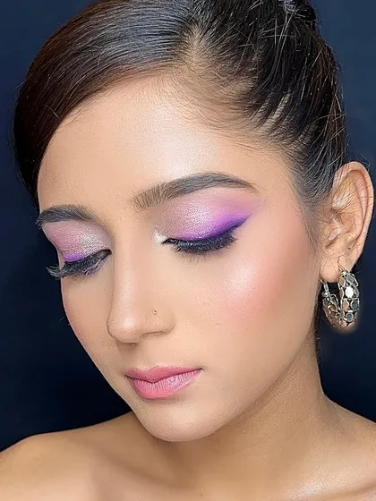 A playful look with a purple winged liner and shimmery lilac on the lids.